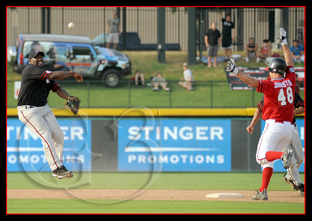 SPORT Baseball Former Oakland Raider Warren Sapp of the Black Sox makes an off balanced throw to first as former Dallas Cowboy Darryl 'Moose' Johnson goes into second