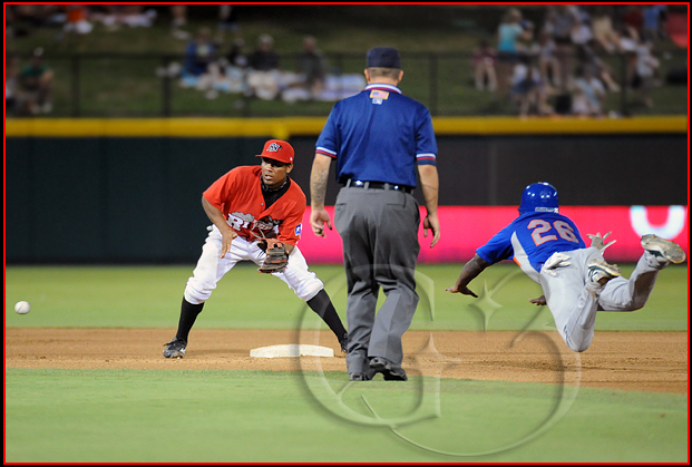 511 Midland Rockhounds base runner Archie Gilbert dives in safely into second base as Frisco Roughriders second baseman Marcus Lemon #1 awaits the throw from the catcher
