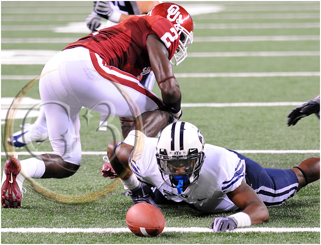 SPORT NCAA FOOTBALL Brigham Young wide receiver O'Neill Chambers #4 tries to reach the ball he fumbled at the one yard line as Oklahoma cornerback Quinton Carter #20 dives in to recover it in the end zone