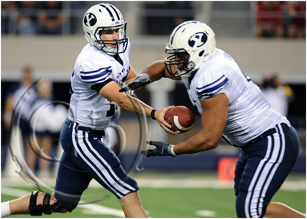 SPORT NCAA FOOTBALL Brigham Young quarterback Max Hall #15 hands the ball off to Brigham Young running back Manase Tonga #11