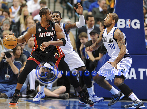 Dec 20, 2012: Miami Heat shooting guard Dwyane Wade #3 is double covered by Dallas Mavericks shooting guard O.J. Mayo #32 and Dallas Mavericks shooting guard Dahntay Jones #30 during an NBA game between the Miami Heat and the Dallas Mavericks at the American Airlines Center in Dallas, TX Miami defeated Dallas 110-95